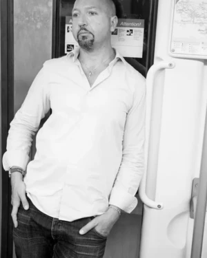 Colin Morgan leaning on a train carriage door - Urban style black and white photography.